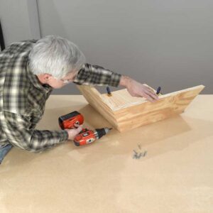 6. Assemble the reflector. Brace two of the reflector sides against a square piece of…